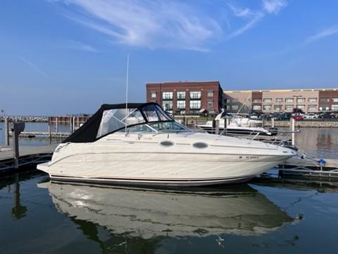 Slide: The Image of 2001 Sea Ray 260 Sundancer docked at a marina on a sunny day. - 1