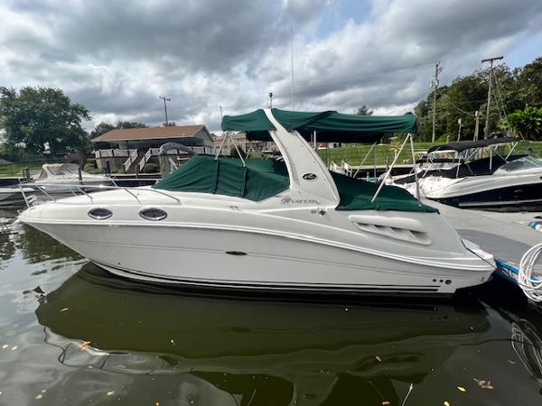 Slide: The Image of 2005 Sea Ray 260 Sundancer boat docked with green canopy. - 1