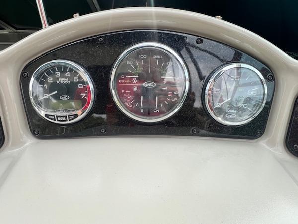 Slide: The Image of Dashboard of a 2005 Sea Ray 260 Sundancer boat with gauges. - 15