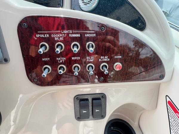 Slide: The Image of Control panel of a 2005 Sea Ray 260 Sundancer boat with various switches. - 17