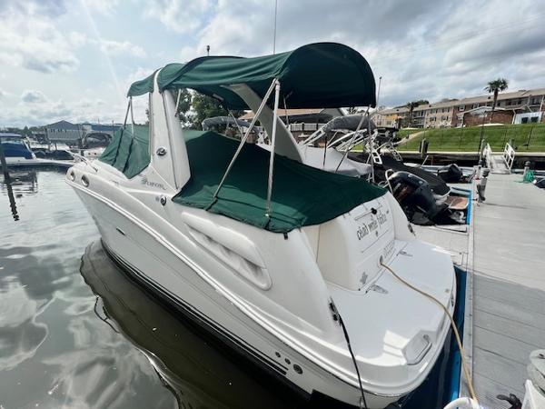 Slide: The Image of 2005 Sea Ray 260 Sundancer docked with green canopy. - 2