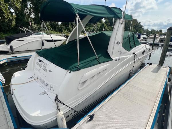 Slide: The Image of 2005 Sea Ray 260 Sundancer docked with green canopy in marina. - 4
