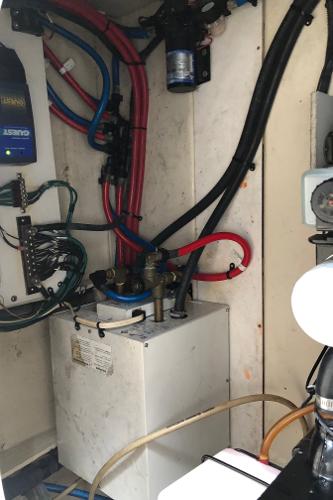 Slide: The Image of Engine compartment of a 2007 Sea Ray 260 Sundancer boat showing wiring and plumbing. - 13