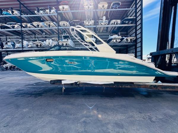 Slide: The Image of 2025 Sea Ray 270 SDX boat in storage, vibrant blue hull, sleek design. - 1