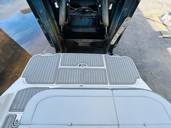 Slide: The Image of 2025 Sea Ray 270 SDX boat on lift, showing rear deck and swim platform. - 10