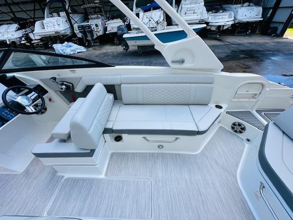 Slide: The Image of 2025 Sea Ray 270 SDX interior with white seating and modern design. - 16
