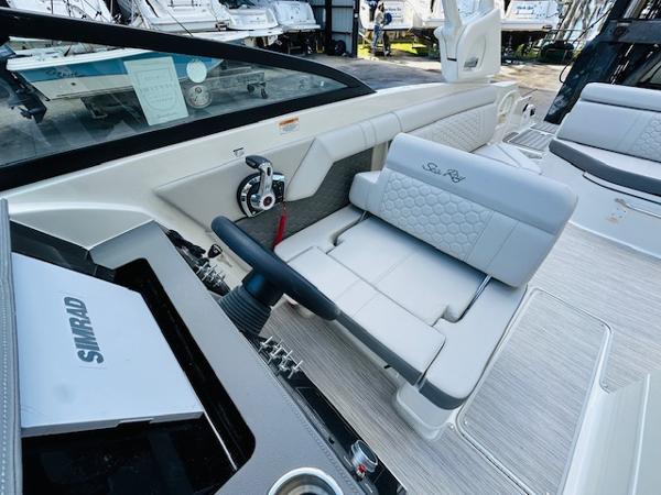 Slide: The Image of 2025 Sea Ray 270 SDX boat interior with steering wheel and seating. - 18
