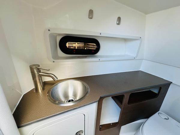Slide: The Image of 2025 Sea Ray 270 SDX boat interior with sink and storage area. - 21