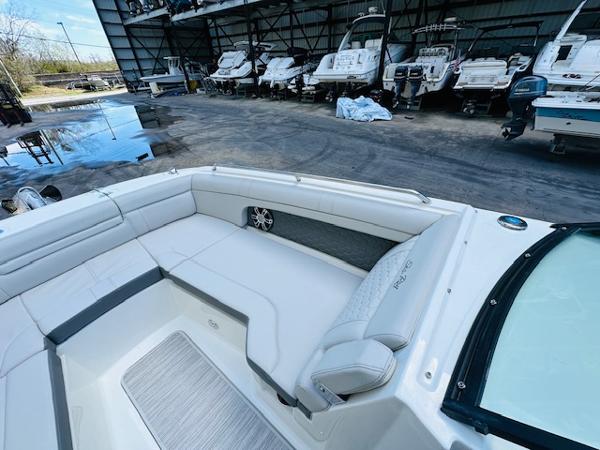 Slide: The Image of 2025 Sea Ray 270 SDX boat interior with spacious seating in a marina setting. - 24