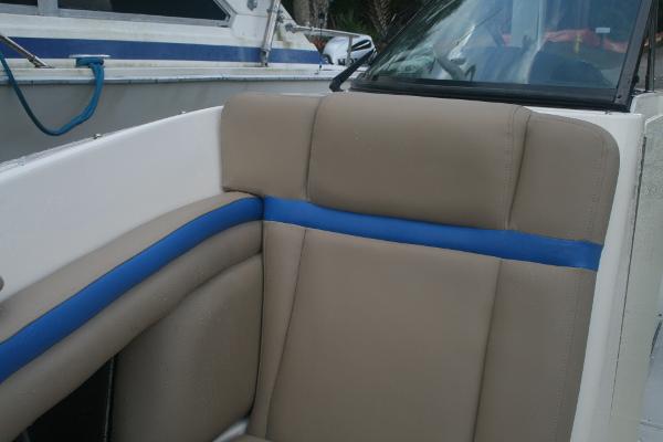 Slide: The Image of 2014 Sea Ray 270 SLX boat interior with beige and blue seating. - 7