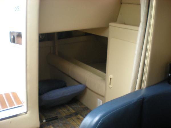 Slide: The Image of 1998 Sea Ray Sundancer 270 cabin interior with seating and storage. - 10