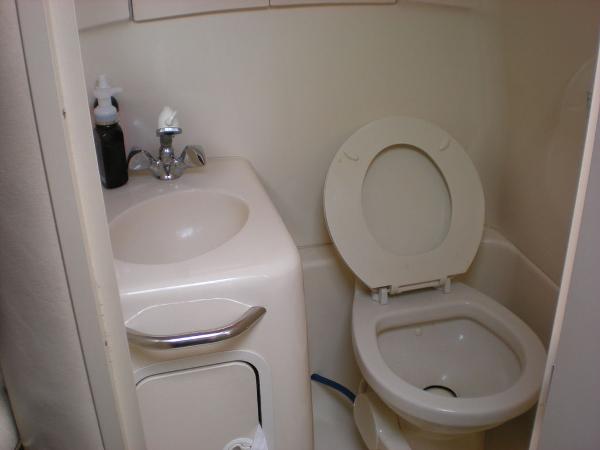 Slide: The Image of Compact bathroom in 1998 Sea Ray Sundancer 270 boat with sink and toilet. - 12