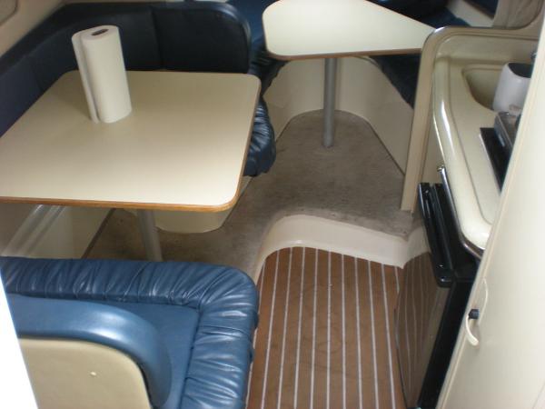 Slide: The Image of 1998 Sea Ray Sundancer 270 cabin interior with dining area and kitchenette. - 4