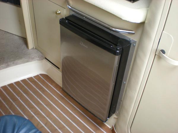 Slide: The Image of 1998 Sea Ray Sundancer 270 interior with stainless steel mini fridge. - 6
