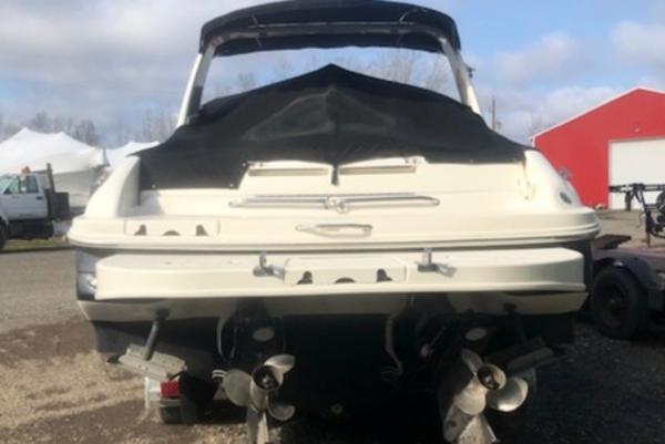 Slide: The Image of 2000 Sea Ray 280 Bow Rider boat, rear view with covered deck and dual propellers. - 1