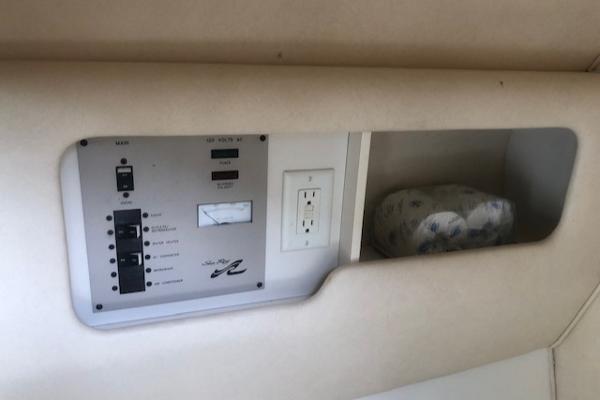 Slide: The Image of Control panel and storage compartment in 2000 Sea Ray 280 Bow Rider boat. - 10