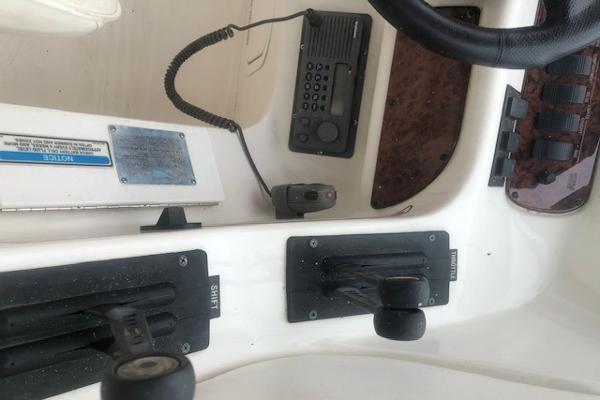 Slide: The Image of Control panel of a 2000 Sea Ray 280 Bow Rider boat with radio and steering components. - 12