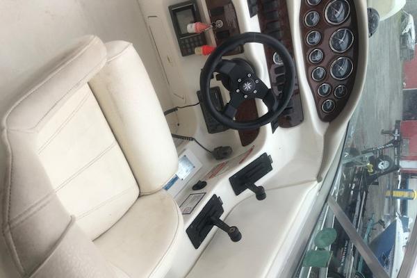 Slide: The Image of Interior cockpit of a 2000 Sea Ray 280 Bow Rider with steering wheel and gauges. - 13