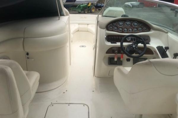 Slide: The Image of 2000 Sea Ray 280 Bow Rider interior with steering wheel and seating, showcasing dashboard controls. - 14