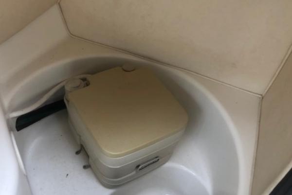 Slide: The Image of Portable toilet in a 2000 Sea Ray 280 Bow Rider boat interior. - 9