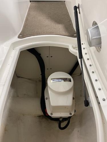 Slide: The Image of 2014 Sea Ray 280 Sundeck storage compartment with electrical components. - 13