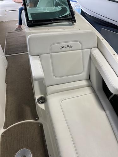 Slide: The Image of 2014 Sea Ray 280 Sundeck interior seating area with white upholstery. - 14