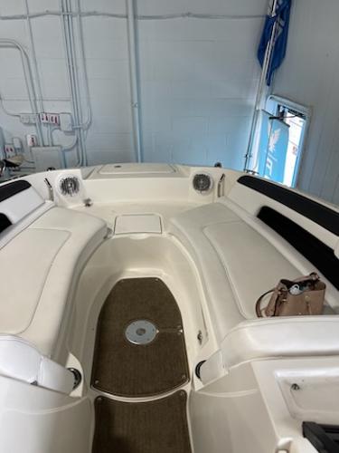 Slide: The Image of 2014 Sea Ray 280 Sundeck interior with white seating and brown flooring. - 15