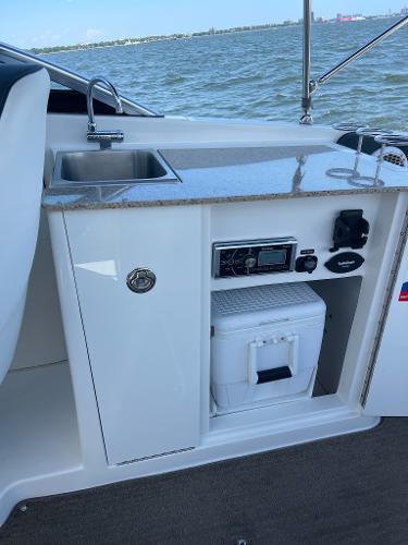 Slide: The Image of 2014 Sea Ray 280 Sundeck boat kitchenette with sink and storage. - 17