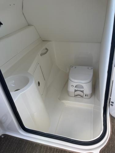 Slide: The Image of 2014 Sea Ray 280 Sundeck boat interior bathroom with toilet and sink. - 18