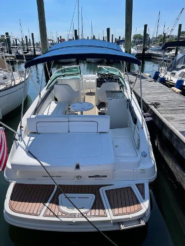 Slide: The Image of 2014 Sea Ray 280 Sundeck boat docked at marina with blue canopy. - 2