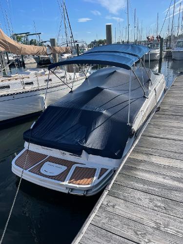 Slide: The Image of 2014 Sea Ray 280 Sundeck boat docked with blue cover and canopy. - 5