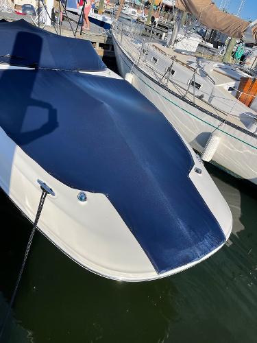 Slide: The Image of 2014 Sea Ray 280 Sundeck boat docked with blue cover. - 6