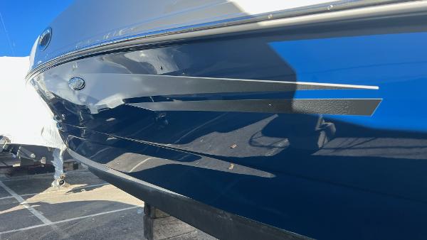 Slide: The Image of 2014 Sea Ray 280 Sundeck boat hull with blue and white detailing. - 8