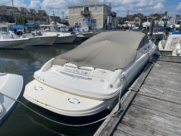 Slide: The Image of 1999 Sea Ray 280 Sun Sport boat docked with cover in marina. - 1