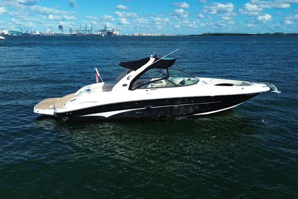 Slide: The Image of 2008 Sea Ray 290 SLX boat on open water under blue sky. - 1