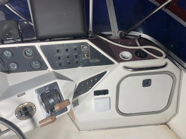 Slide: The Image of 1989 Sea Ray 300 Sedan Bridge helm with control panel and gauges. - 11