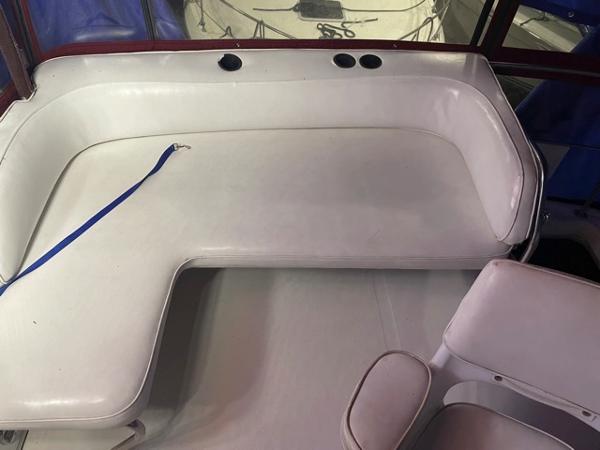 Slide: The Image of 1989 Sea Ray 300 Sedan Bridge interior seating area with white upholstery. - 12