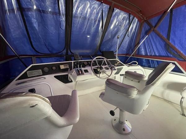 Slide: The Image of Interior helm of 1989 Sea Ray 300 Sedan Bridge with steering wheel and captain's chairs. - 16