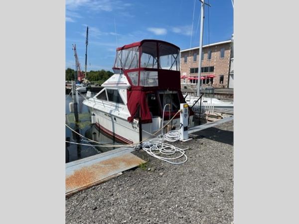 Slide: The Image of 1989 Sea Ray 300 Sedan Bridge docked at a marina. - 2