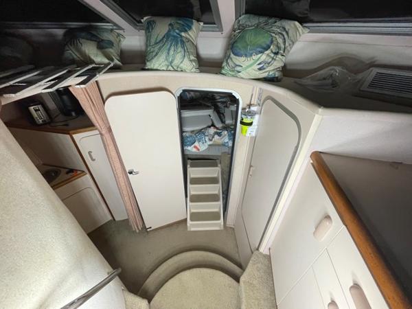 Slide: The Image of Interior cabin of a 1989 Sea Ray 300 Sedan Bridge boat with stairs and storage. - 23
