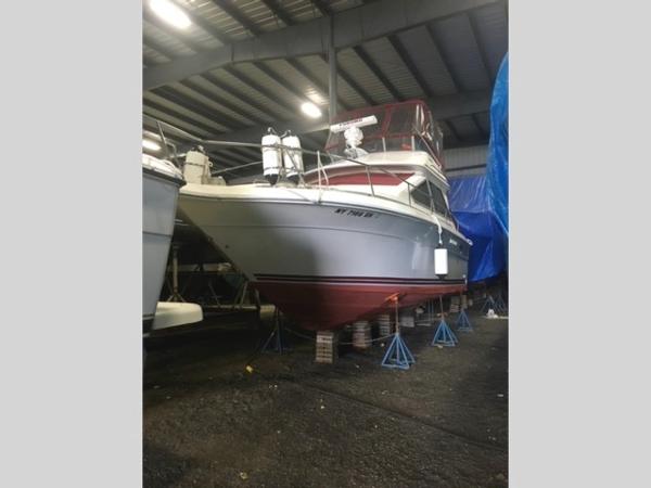 Slide: The Image of 1989 Sea Ray 300 Sedan Bridge boat in storage on stands. - 6