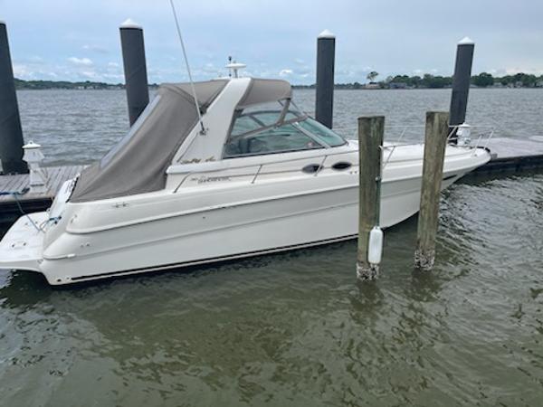 Slide: The Image of 1999 Sea Ray 310 Sundancer docked at a marina. - 3