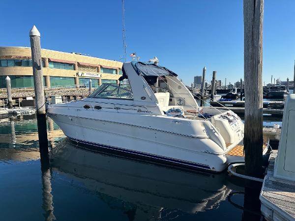 Slide: The Image of 2002 Sea Ray 310 Sundancer docked at a marina. - 1