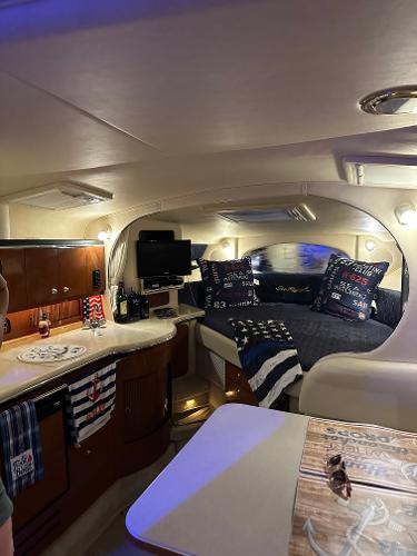 Slide: The Image of Interior of 2002 Sea Ray 310 Sundancer with cozy cabin and modern amenities. - 18