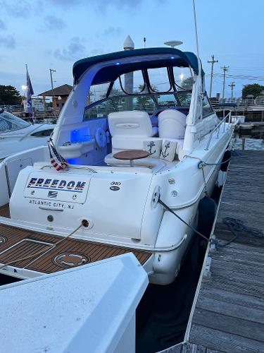 Slide: The Image of 2002 Sea Ray 310 Sundancer docked at marina, rear view. - 8