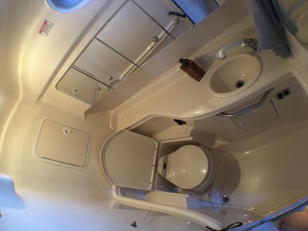 Slide: The Image of Bathroom interior of 2002 Sea Ray 320 Sundancer yacht, featuring toilet and sink. - 15