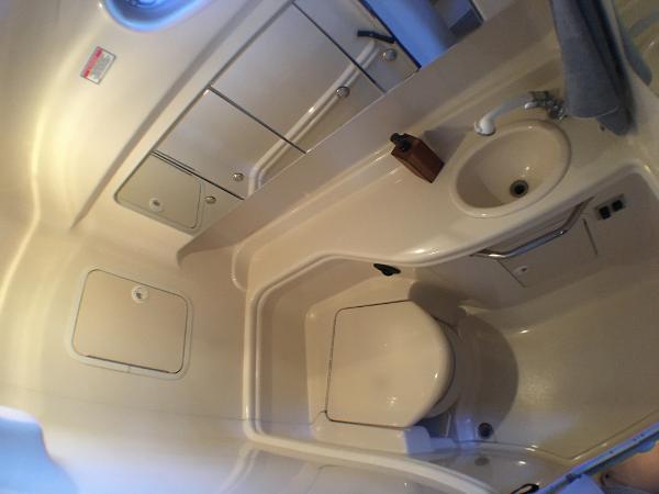 Slide: The Image of 2002 Sea Ray 320 Sundancer bathroom with sink, toilet, and storage cabinets. - 16