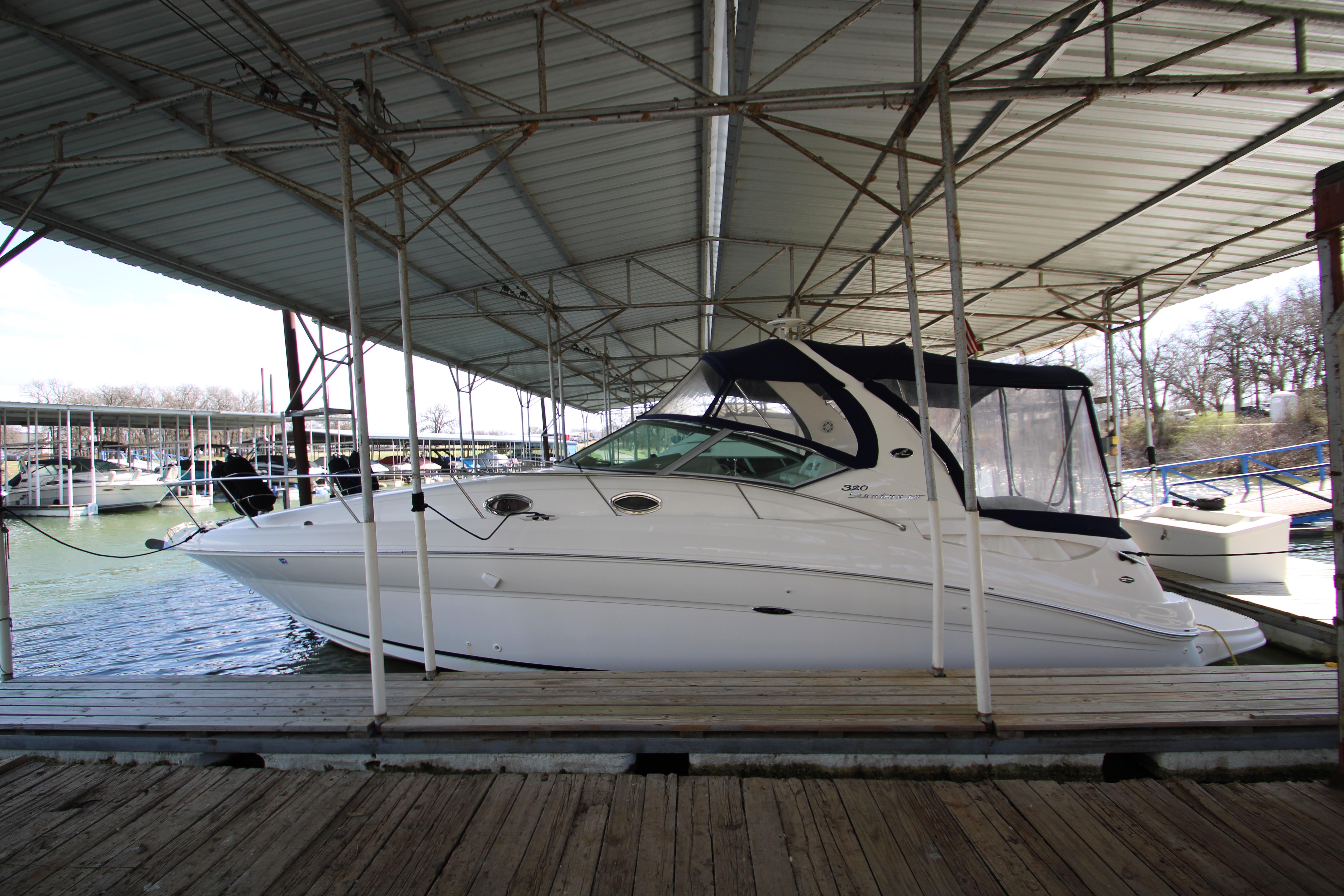 Slide: The Image of 2003 Sea Ray 320 Sundancer docked under covered marina. - 0