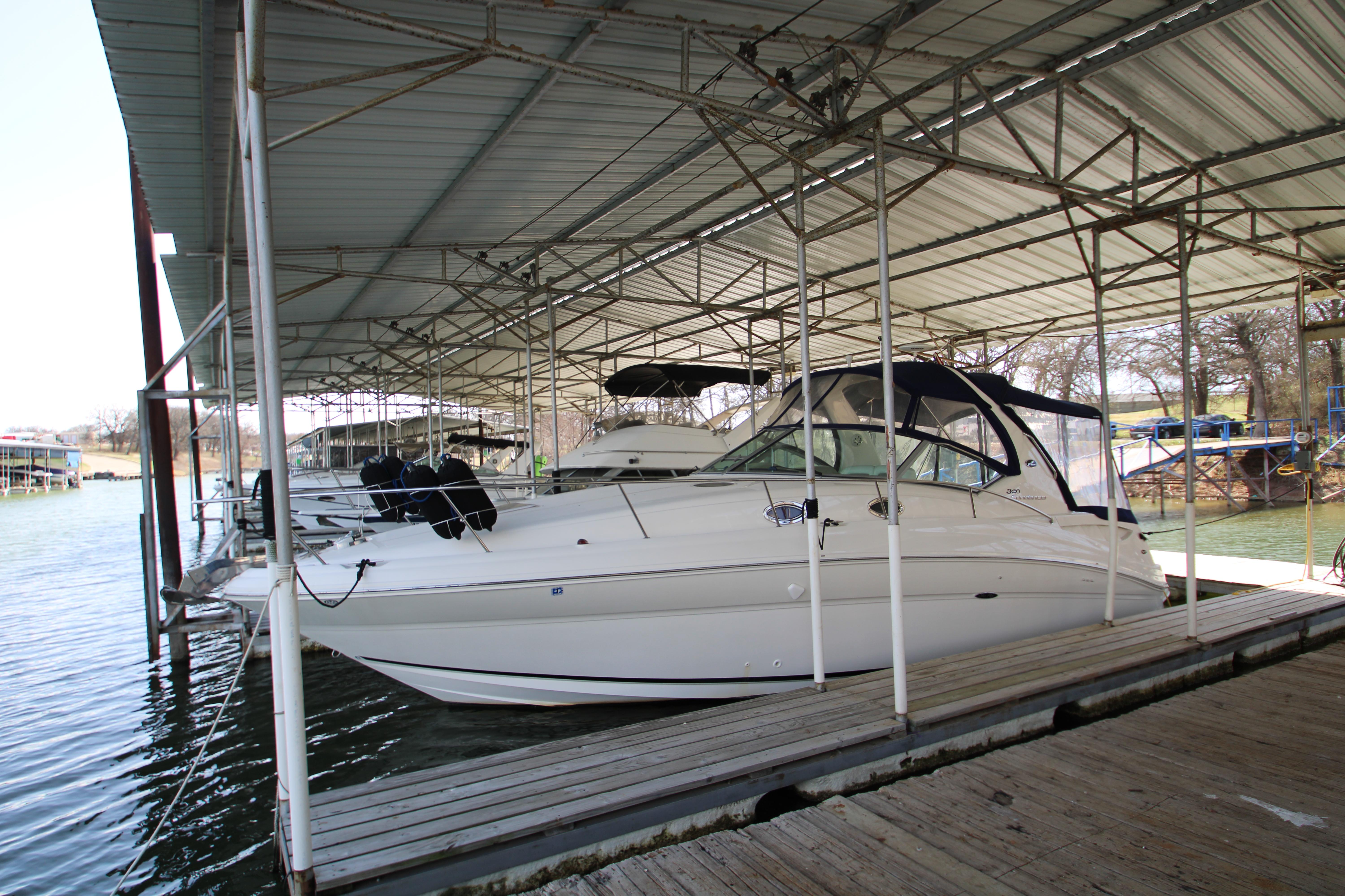 Slide: The Image of 2003 Sea Ray 320 Sundancer docked under covered marina. - 2