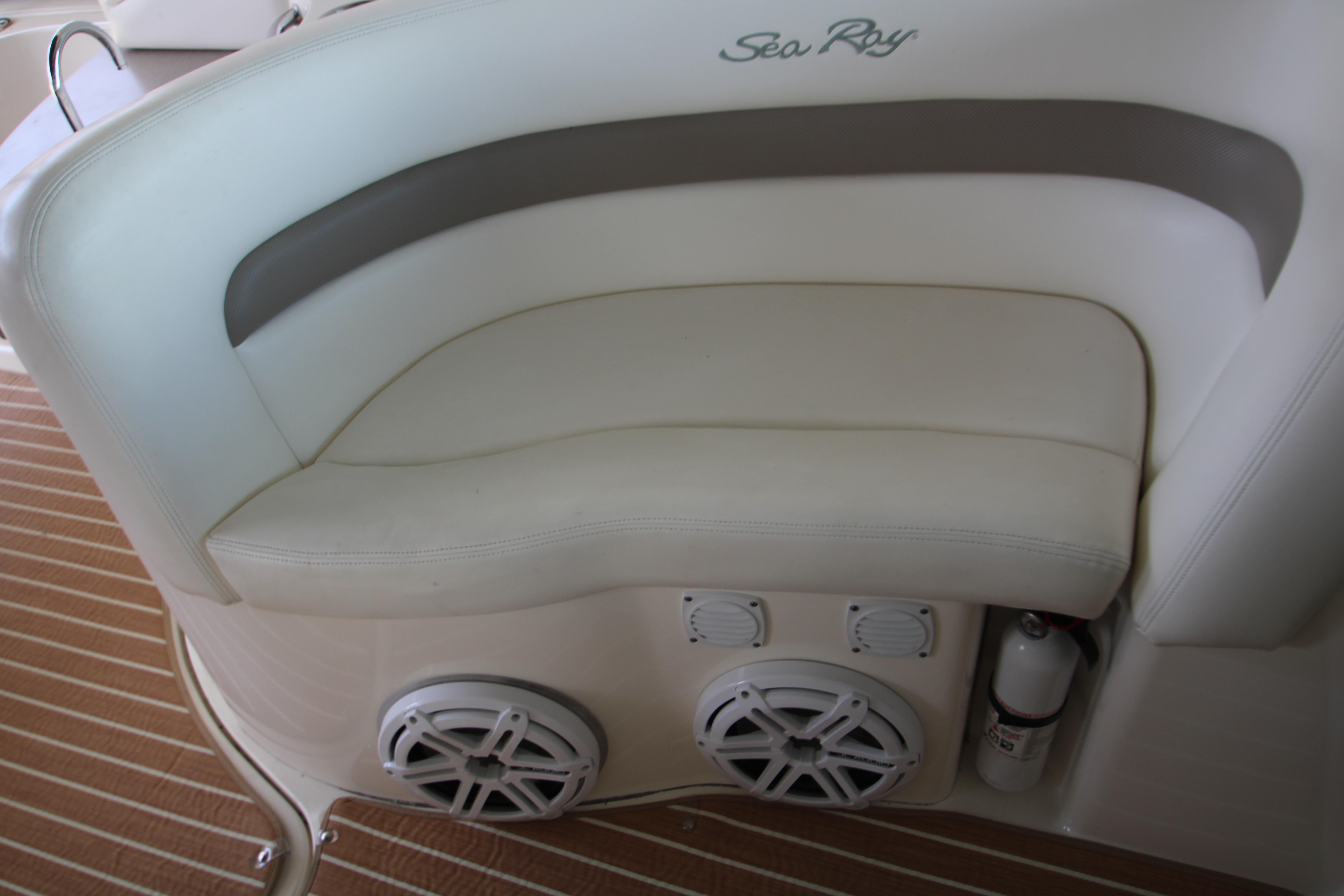 Slide: The Image of 2003 Sea Ray 320 Sundancer boat interior with cushioned seating and built-in speakers. - 30